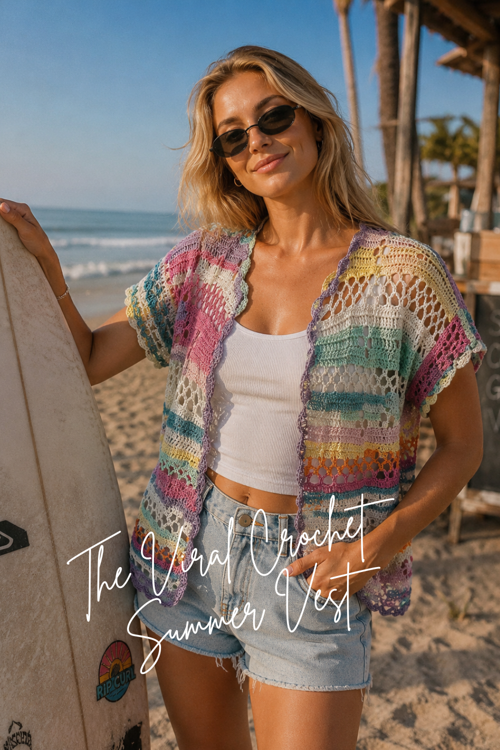 Woman wearing the Coastal Bloom crochet cardigan pattern at the beach, colorful summer crochet cover-up with boho style.