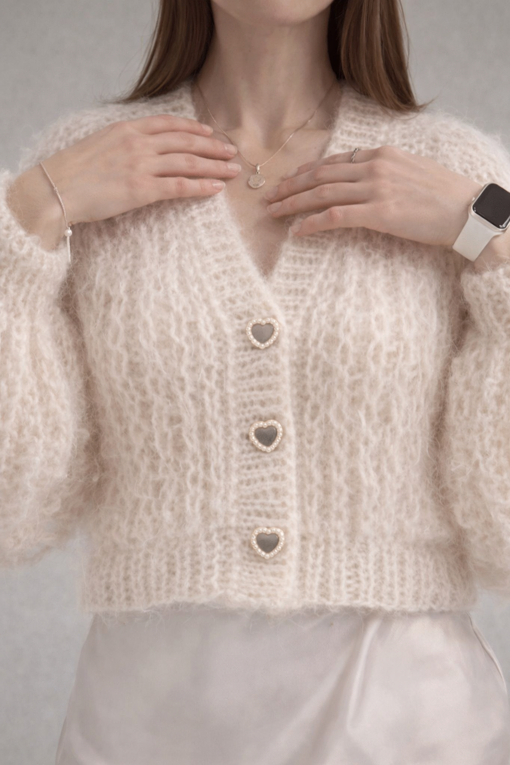 Soft oversized alpaca silk balloon cardigan hanging on a hanger, airy half fisherman rib stitch with light and cozy texture
