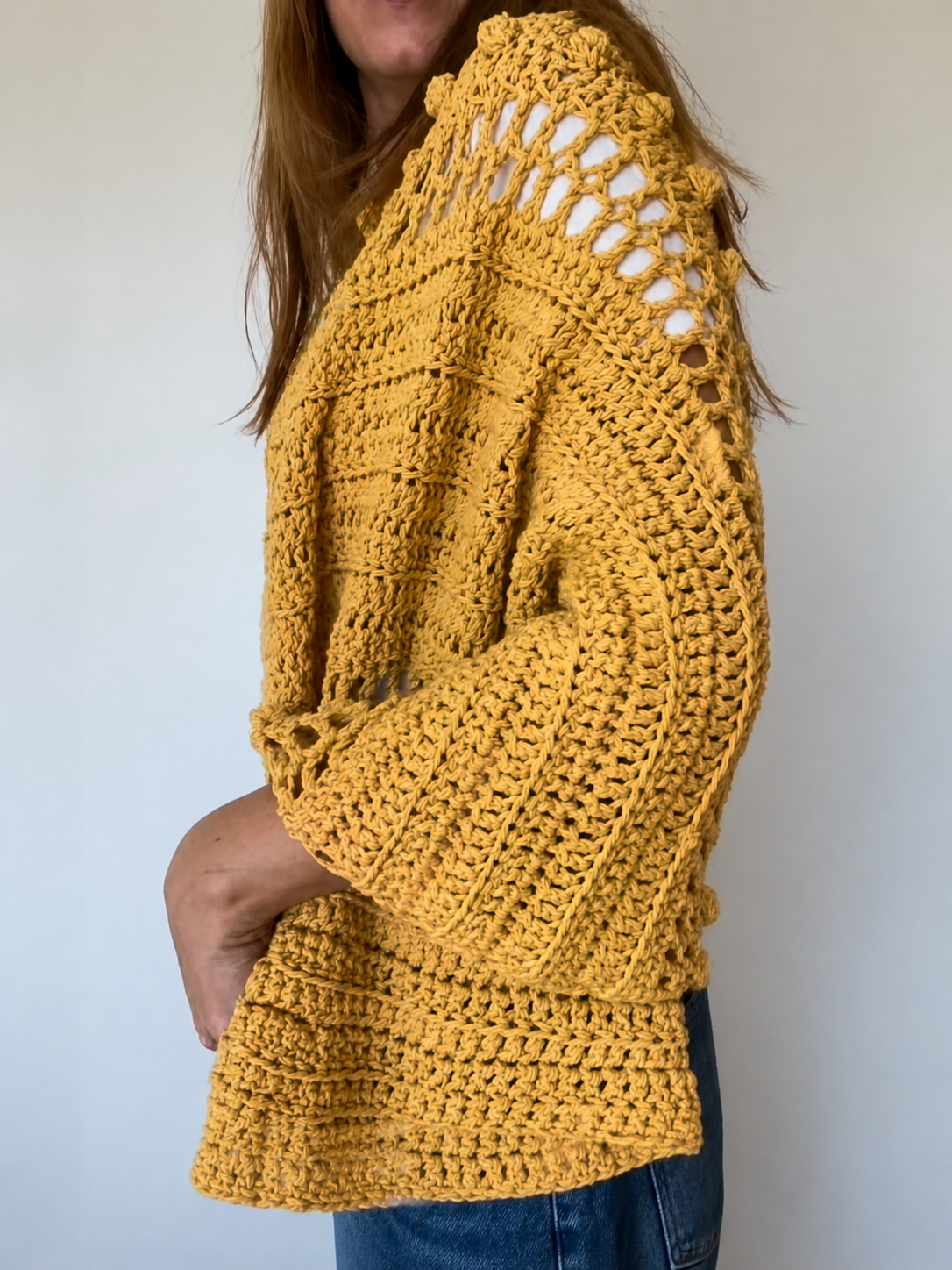Detailed crochet texture of the Golden Hour Wrap featuring modern openwork stitches and soft yarn.